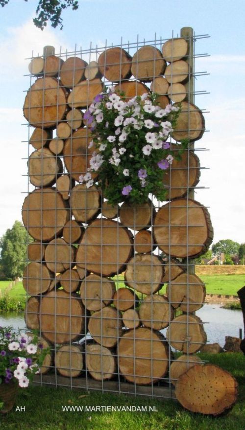 Cordwood fence with wire mesh panels.jpg